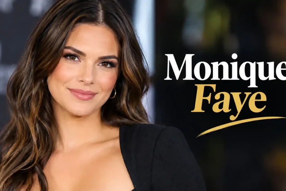 Monique Faye smiling with long wavy brown hair wearing a black top and gold hoop earrings